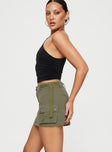   side view of model wearing Princess Polly Take You Cargo Mini Skirt Green Mini Skirts 