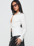 side view of model wearing Princess Polly Fleiry Long Sleeve Top White Full Sleeves V-Neck 