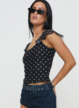 side view of model wearing Princess Polly Beckinsale Polka Top Black Short Sleeves Scoop Neck 