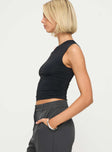 side view of model wearing Princess Polly Stela Top Black Sleeveless Asymmetric Neckline 