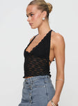 side view of model wearing Princess Polly Only Angel Halter Top Black Sleeveless Scoop Neck 