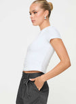 side view of model wearing Princess Polly Harrish One Shoulder Top White Short Sleeves Asymmetric Neckline 