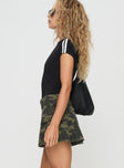 side view of model wearing Princess Polly Remington Skort Green Camo mid-rise 