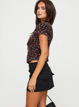   side view of model wearing Princess Polly Stafford Low Rise Mini Skirt Black Mini Skirts 