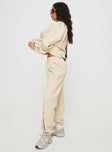 side view of model wearing Princess Polly Princess Polly Track Pants Block / Cursive Text Stone Mid Rise 