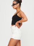 side view of model wearing Princess Polly Katlynne Denim Mini Skort White mid-rise 