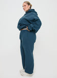 side view of model wearing Princess Polly Princess Polly Track Pants Block / Cursive Text Slate Curve 