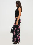   side view of model wearing Princess Polly Modalla Maxi Skirt Black Floral Maxi 