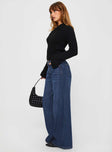 side view of model wearing Princess Polly Naylor Wide Leg Jeans Mid Blue Denim Tall Mid Rise 