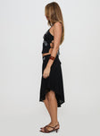   side view of model wearing Princess Polly Pappilion Asymmetrical Midi Skirt Black Midi Skirts 