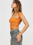 side view of model wearing Princess Polly Shakman Lace Top Orange Short Sleeves Sweetheart 