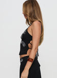 side view of model wearing Princess Polly Pappilion Top Black Sleeveless Plunger 