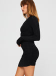 side view of model wearing Princess Polly Orara Long Sleeve Mini Dress Black Asymmetric Neckline 