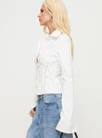 side view of model wearing Princess Polly Merritt Top White Full Sleeves High Neck 