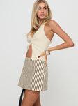 side view of model wearing Princess Polly Gigi Skort Beige Stripe Tall High Waisted Shorts 