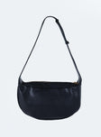 Black shoulder bag Faux leather material Adjustable shoulder strap Zip fastening  Gold toned hardware Flat base