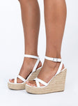 Woven base  Faux leather upper Strappy upper  Bucket fastening at ankle  Wedge heel  Platform base 