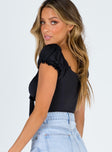 side view of model wearing Princess Polly Medina Bodysuit Black Short Sleeves Sweetheart 