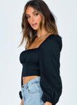 side view of model wearing Princess Polly Ariah Long Sleeve Top Black Full Sleeves Square Neck 