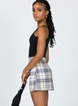   side view of model wearing Princess Polly Selby Mini Skirt Yellow Plaid 