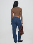 back view of model wearing Princess Polly Forestier Pin Tuck Jeans Mid Blue High Waisted 