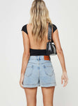 back view of model wearing Princess Polly Gazelle Denim Skort Light Wash High Waisted Shorts 