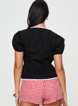 back view of model wearing Princess Polly Ryota Blouse Black Short Sleeves Crew Neck 