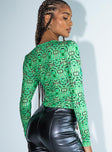 side view of model wearing Princess Polly Hypnotize Bodysuit Green Full Sleeves Crew Neck 