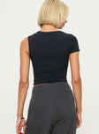 back view of model wearing Princess Polly Stela Top Black Sleeveless Asymmetric Neckline 