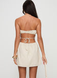 back view of model wearing Princess Polly Luvstruck Strapless Mini Dress Beige Straight Neck 