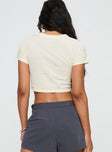 back view of model wearing Princess Polly Barnabase Tee Cream Short Sleeves Crew Neck 