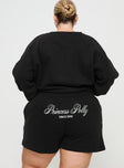 back view of model wearing Princess Polly Princess Polly Track Shorts Cursive Text Black Sand Curve High Waisted Shorts 