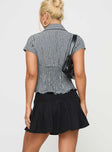 back view of model wearing Princess Polly Anubis Pleat Mini Skirt Black Mini Skirts 