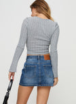 back view of model wearing Princess Polly Arrte Mid Rise Denim Mini Skirt Mid Wash Petite Mini Skirts 