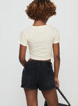 back view of model wearing Princess Polly Amethysta Denim Skort Black High Waisted Shorts 