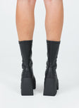 Boots  Faux leather material  Fitted at leg  Block heel  Platform base  Square toe  Slight stretch 