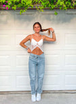 Front view of model wearing  front Princess Polly High Waisted  Holly Asymmetric Straight Leg Jean Light Wash Denim Petite