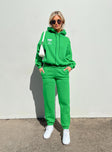 Front view of model wearing  front Princess Polly  Pheonix Track Pants Apple Green