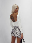 Front view of model wearing  front Princess Polly Sleeveless Asymmetric Neckline  Rixie Long Sleeve Top White