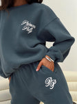 back view of model wearing Princess Polly Princess Polly Crew Neck Sweatshirt Cursive Text Navy / White 