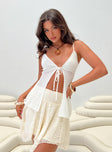 Longline crochet top Adjustable shoulder straps, v-neckline, tie fastening at bust, split hem