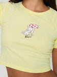 side view of model wearing Princess Polly Kewpie Best Of Friends Baby Tee Yellow Short Sleeves Crew Neck 