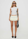 front view of model wearing Princess Polly Deei Double Ruffle Mini Skort Soft Lemon Low Rise Shorts 