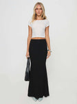   side view of model wearing Princess Polly Topping Maxi Skirt Black Tall Maxi 