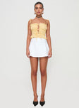 front view of model wearing Princess Polly Reema Skort White High Waisted Shorts 