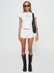 front view of model wearing Princess Polly Femme Micro Short White Low Rise Shorts 