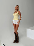 side view of model wearing Princess Polly Stellah Top Yellow Sleeveless Sweetheart 