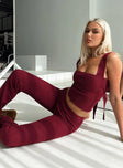 side view of model wearing Princess Polly Closed Eyes Flared Pants Maroon Low Rise Pants 