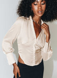 Long sleeve shirt Silky material Classic collar V neckline Button fastening at front Lace up fastening at back Button detail at cuff