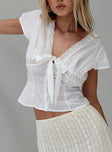 Top V-neckline, knit lace trim, tie detail at bust, button fastening at front